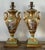 This magnificent pair of French Empire-style table lamps offers a masterclass in Neoclassical elegance and mid-century...