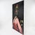 A compelling contemporary oil painting portraying a figure in profile, dressed in a vivid pink garment and adorned with a...