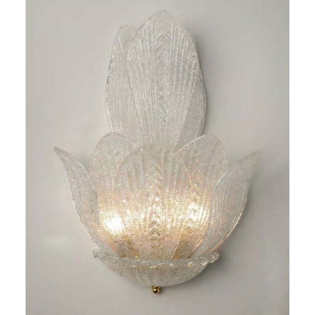 Italian wall light with clear Murano glass leaves hand blown in Graniglia technique to produce granular textured effect,...