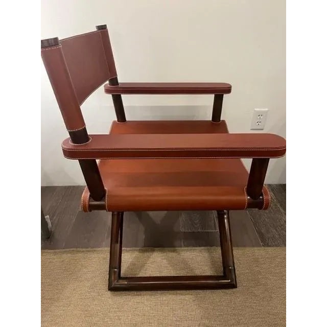 A modern take on a iconic director's chair. Crafted from solid mahogany wood with a cross braced frame. Featuring an...