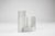 A flower vase centerpiece made of white glazed ceramic, consisting of three interlocking pieces. Manufacturer’s label on...