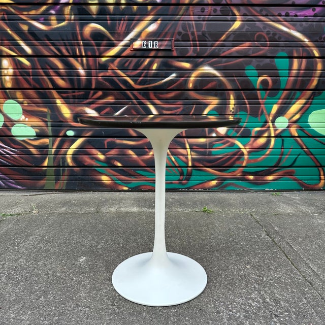 Cute, vintage Burke Division for Brunswick Tulip bistro or side table comprised of a wood grain laminate top with a black...