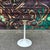 Cute, vintage Burke Division for Brunswick Tulip bistro or side table comprised of a wood grain laminate top with a black...