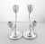 A pair of sterling silver two-branch candelabras from 1952. The taller candleholder stands at 10 inches while the other is...