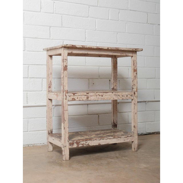 This vintage wooden shelf features beautifully worn, original distressed paint that tells a story of decades of use and...