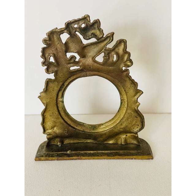 Hunters motive antique brass pocket watch stand. The inner opening is 3,5”.