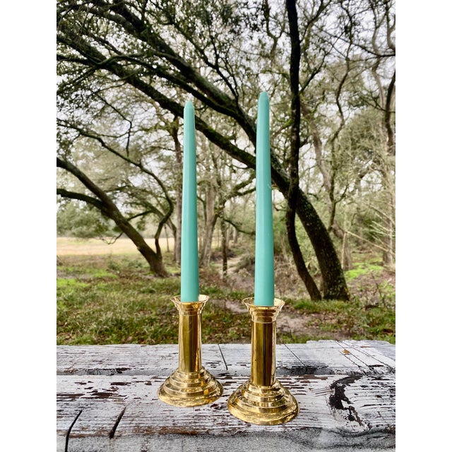 This exceptional duo of brass candle holders exemplifies a refined fusion of neoclassical elegance and minimalist form....