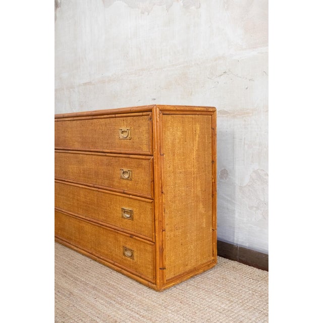 Bamboo And Rush Fabric Chest Of Drawers – 1970s Bamboo frame with an amber finish, covered in rattan fabric. Four drawers...