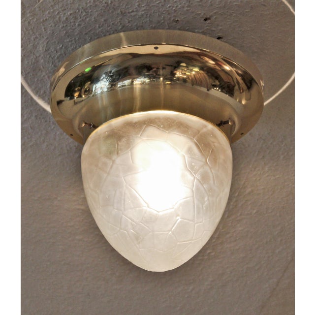 Art Deco ceiling lamp, circa 1920. Brass body with a beautiful frosted glass shade. Polished brass with a baked-on enamel...