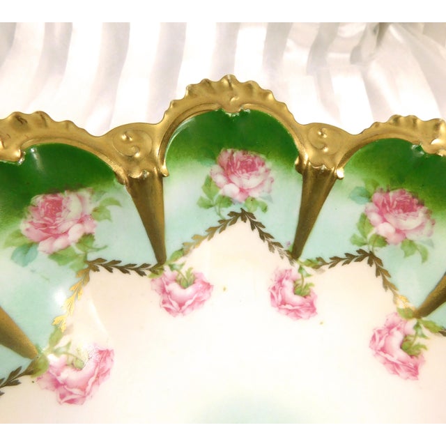 This is a large green and white serving bowl from MZ Austria. It has a pink floral design and gold trim. It has two marks...