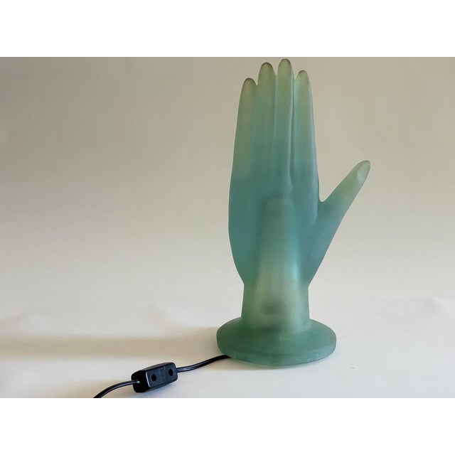Resin hand in rare mint slash celadon green colorway. Serafini’s surrealist table lamp—part sculpture, part functional...