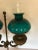 A wonderful antique bronze table or desk lamp that was originally an old oil lamp having double cased green lampshades....