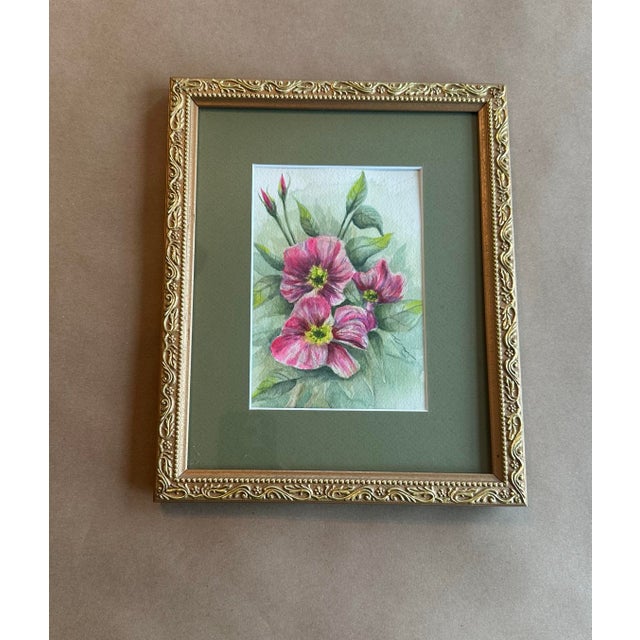 A delicate original watercolor featuring soft pink blossoms with fresh green foliage, rendered in a naturalistic style....