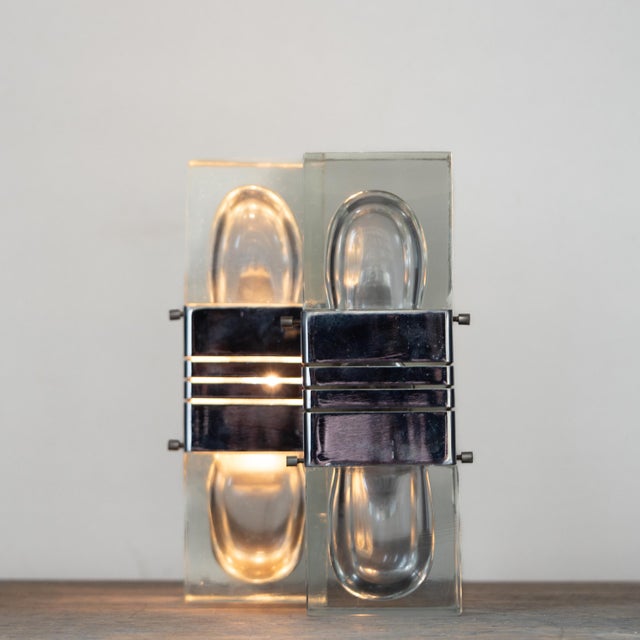 Splendid pair of 1970s wall lamps. Italian design. Murano glass and chromed brass. They can be mounted vertically or...