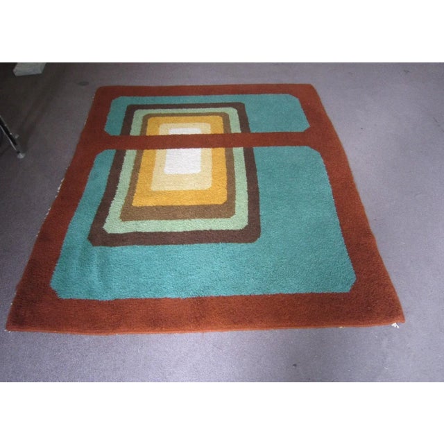 Abstract bold patterned geometric, vintage carpet in colorful shades of russet, greens, ochres, gold, browns. Square and...