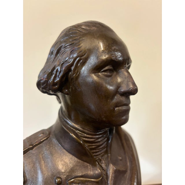 A plaster bust of George Washington with a bronze finish applied to give it a more regal appearance. George has...