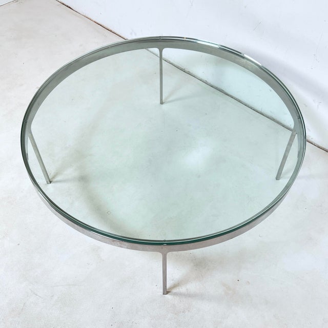 A coffee table in solid stainless steel with thick glass top circa 1970s by the Greek born industrial designer and...