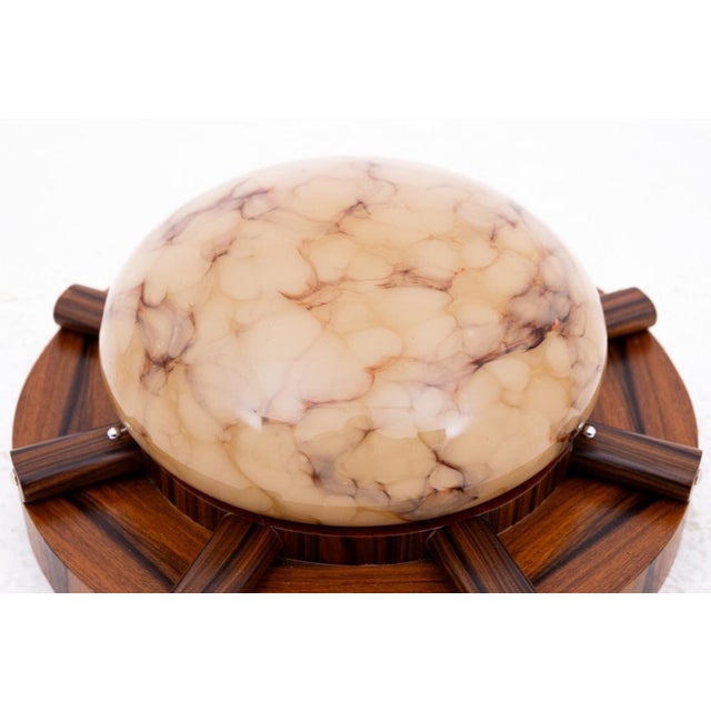 Art Deco lamp/ceiling lamp, Poland, 1950s. Ceiling lamp on a wooden base with a geometric form characteristic of the Art...