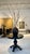A striking vintage round pedestal table with a sculptural, carved base and a dark warm charcoal grey finish. Early 20th...
