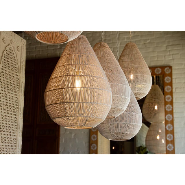 A luminous study in architectural geometry and airy transparency, this pendant represents a sophisticated intersection of...