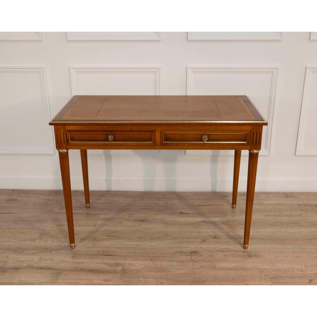 This refined Louis XVI–style desk is crafted in blond mahogany and exemplifies the elegance and symmetry associated with...