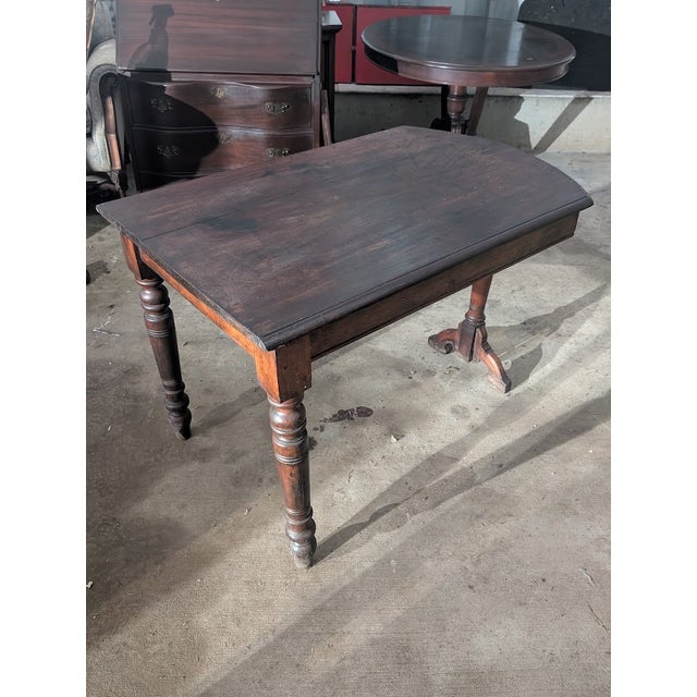 Timeless vintage mahogany tripod pedestal table featuring a gracefully shaped rectangular top with rounded corners, a...