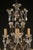 An elegant late 19th-century antique chandelier featuring an iron frame adorned with crystal accents and an impressive...