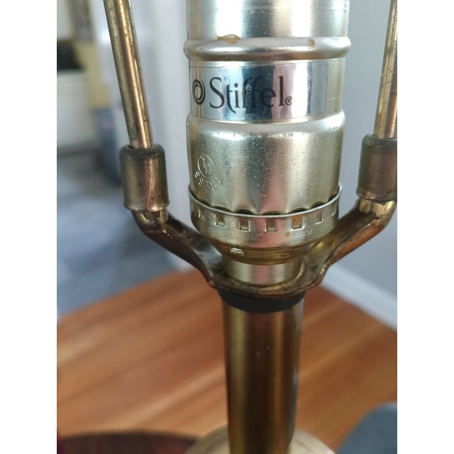Elevate your space with this striking vintage Stiffel table lamp, a sculptural blend of solid brass and cream ceramic that...