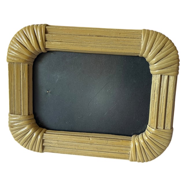 A beautifully detailed vintage picture frame crafted in bamboo with sculptural wrapped rattan corners, evoking the relaxed...