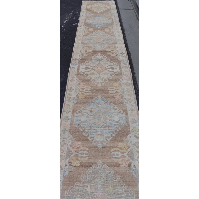 Brown Long Turkish Oushak Runner With Pale Blue, Soft Yellow, and Light Brown Motifs For Sale - Image 8 of 13