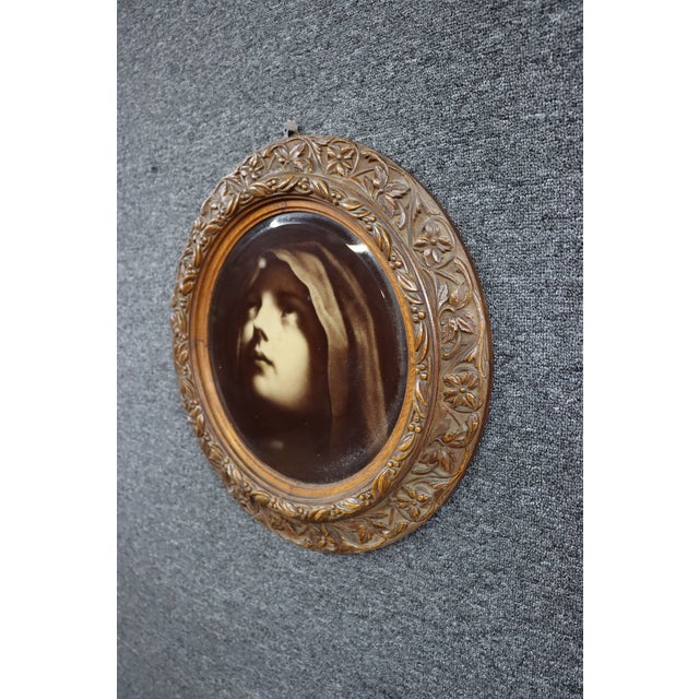 Antique Victorian lithographic portrait of a veiled woman, housed in an ornate quarter-sawn oak frame with carved floral...