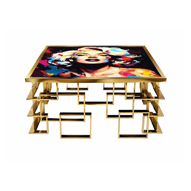 A contemporary designer coffee table, embellished with a vibrant pop art graphic dedicated to Marilyn Monroe. The top...