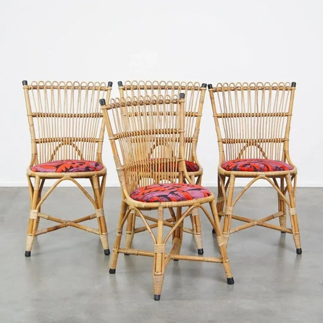 We are offering this set of 4 subtle and charming vintage 1960s rattan boho chairs with colorful upholstered seats. This...