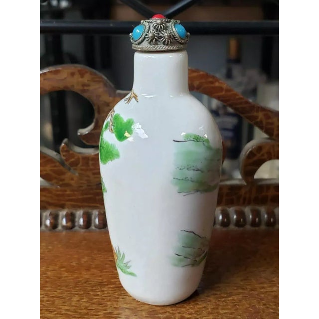 This is a Mid 20th Century Chinese Porcelain Goats Motif Snuff Bottle. It measures 3 1/8" tall and 1 1/4" in diameter. The...