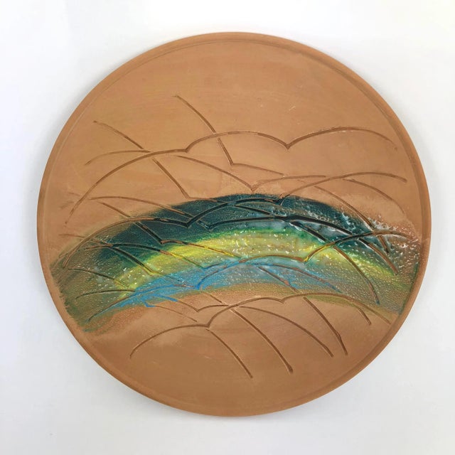 Ornamental plate made with the traditional technique of ceramics, on red clay. Hand decorated, partially glazed and fired....