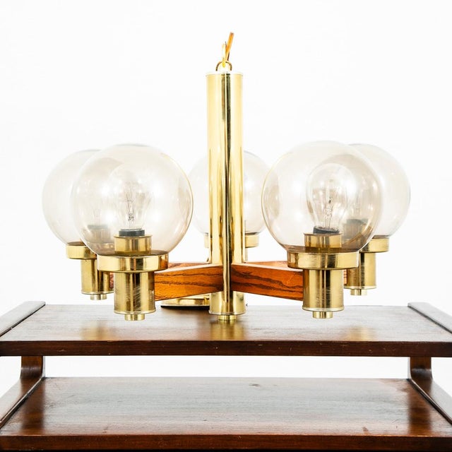 Outstanding example of American 1950-1960s lighting design. the frame of the piece is made up of solid oak with brass...