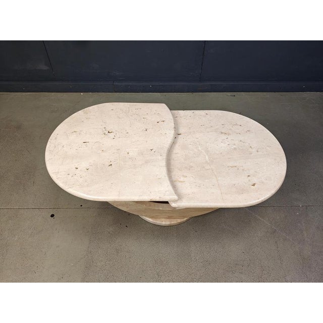 Timeless travertine coffee tables with two nicely shaped tops. The tops can be turned around to create a different setup....