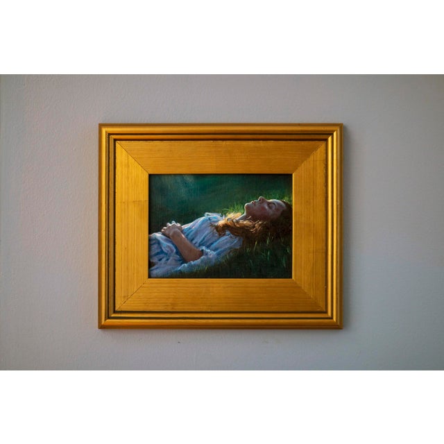 This oil on panel artwork portrays a serene figure lying on lush grass, embodying a moment of tranquility and...