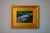 This oil on panel artwork portrays a serene figure lying on lush grass, embodying a moment of tranquility and...