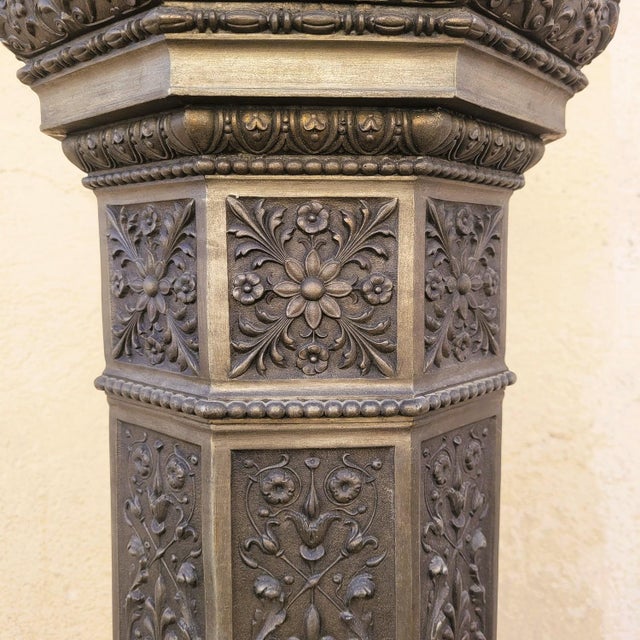 Large spelter torchiere depicting a woman in a draped dress, holding a lantern at arm's length: a beautiful glass globe...