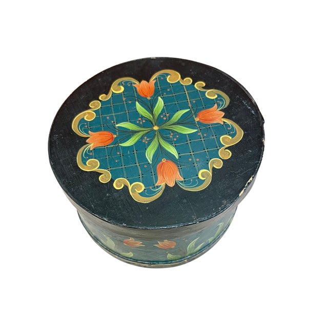 A vintage American Shaker-style bentwood sewing box, circa 1980s, hand painted with stylized tulips, scrolling foliage and...