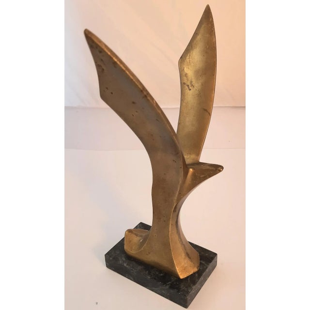 Mid century flying bird solid brass figurine. Original patina intact. No makers mark on stone base. Brutalist in design....