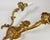 An elegant Pair Of Louis XVI style Wall Lights Circa 1960 in finely chiseled and gilded bronze with two light arms. Fake...