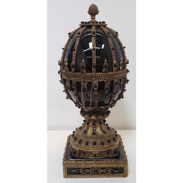 A monumental statement piece of exceptional heft and architectural presence. This 13.5-inch tall Empire Style egg is a...