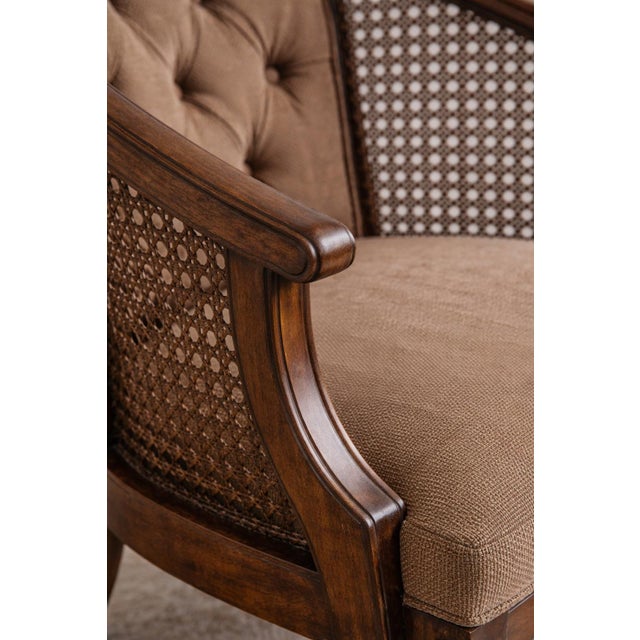 This refined pair of vintage lounge chairs dates to the 1970s and features sculptural hardwood frames, original cane...