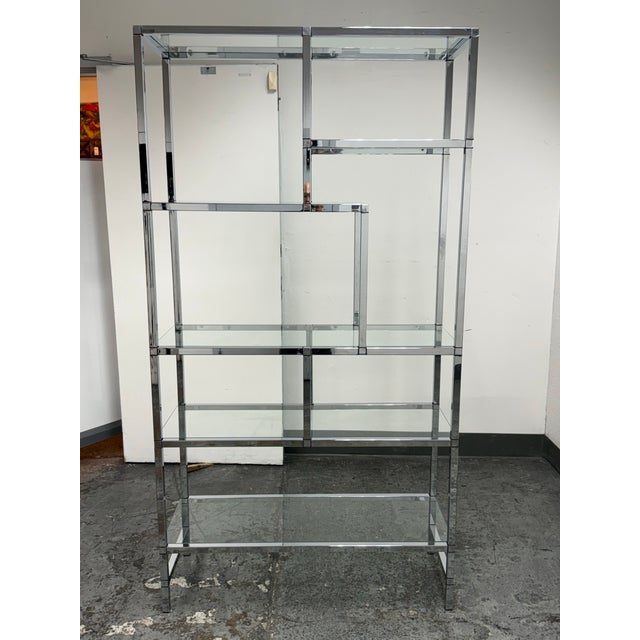 Design Plus Gallery presents the 1970's Chrome and Glass Étagère, in the style of Milo Baughman for Design Institute of...