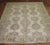 An early 20th century antique Turkish Oushak rug with a beige-colored ground, accents in brown Measures: 9'9'' x 12'2''.