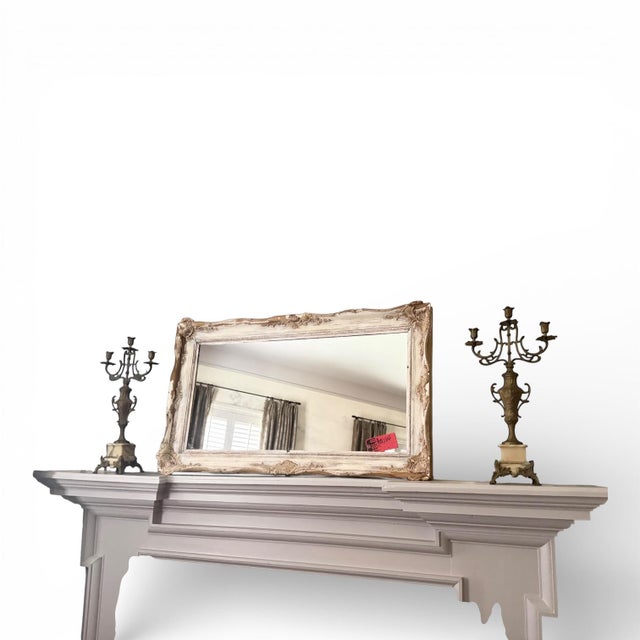 An elegant pair of antique Italian bronze candelabras featuring scrolling Rococo arms and richly detailed urn-form stems,...