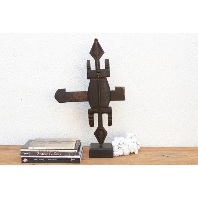 This antique tribal door lock, hand-carved from wood in Mali, Africa, is more than just a functional object; it's a...