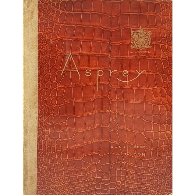 11 3/8" x 8 7/8" Asprey and Co. Ltd. New Bond Street, London. No date [1930s]. Hardback; laminated crocidle-effect boards,...
